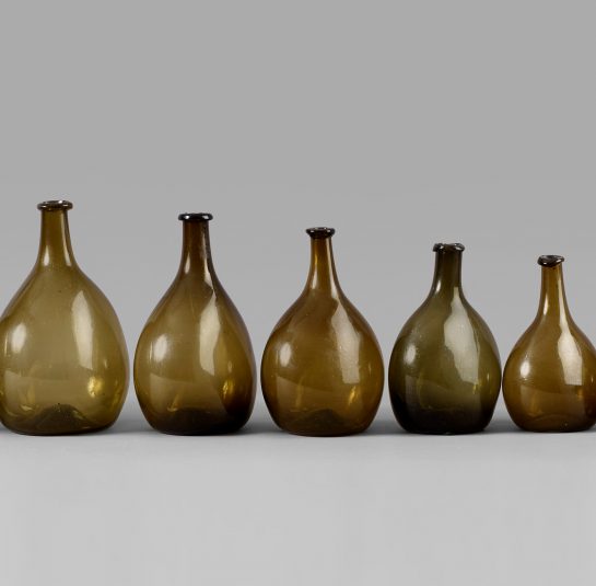 An Exceptional Set of 13 Graduated Blown Chestnut Bottles